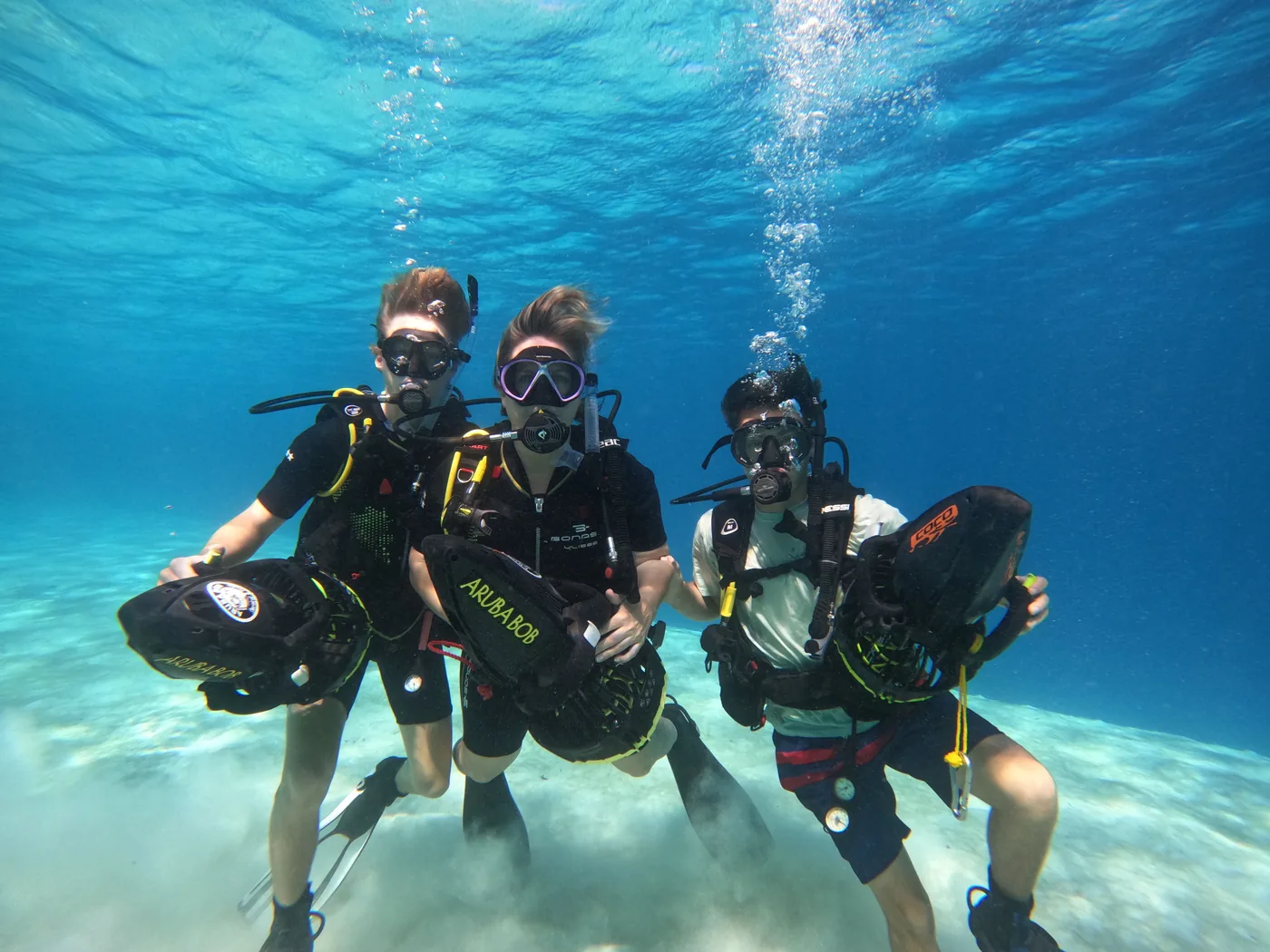 Guests walking into Aruba water for a sea scooter tour
